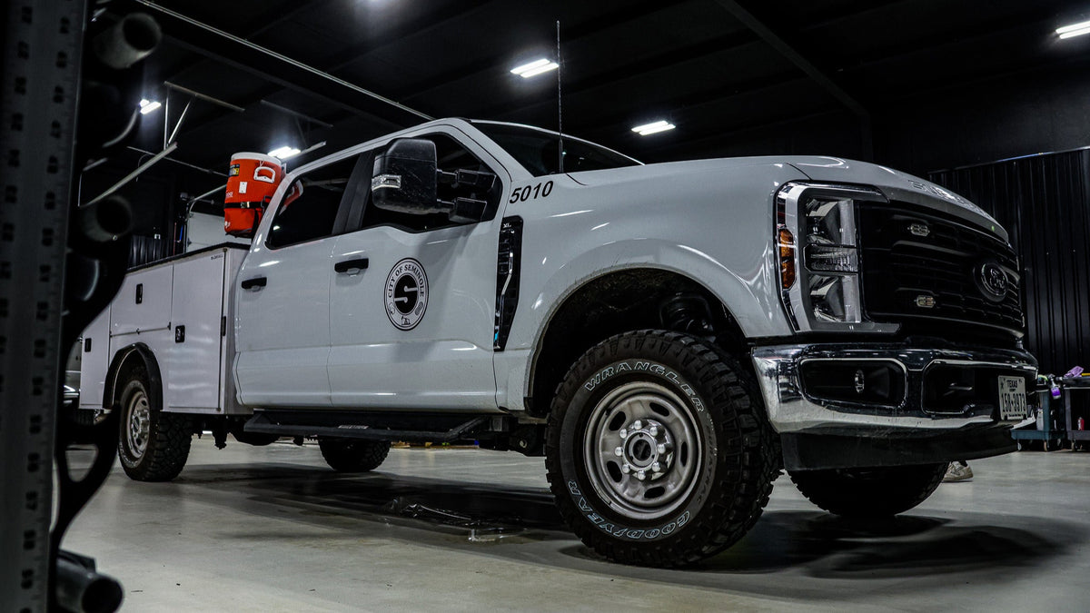 Raskull-upfitted white work truck inside the shop bay